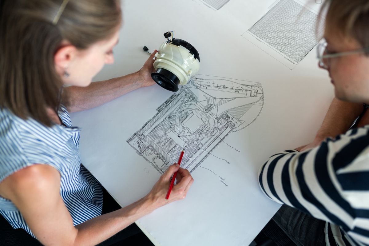 Engineers reviewing a confidential custom manufacturing drawing